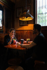 Couple enjoying drinks in traditional irish pub