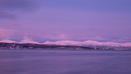 panoramic view of snow mountain and vast sea with pink color during polar night,  Br&oslash;stad, Norway