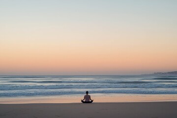 Person meditating on beach at sunset, blank background.
