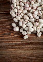 Lots of delicious candies on a brown wooden background. Dried fruits in white chocolate.