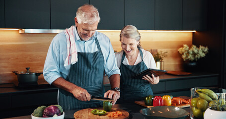 Laughing, cooking and mature couple with vegetables, tablet or chopping of ingredients for cuisine in home. Healthy food, help or people with research for dinner, recipe or culinary skills in kitchen
