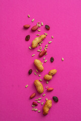Nuts, raisins and sesame seeds on a colored background