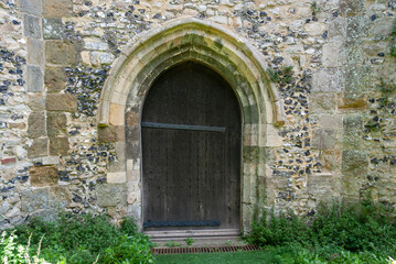 Withered wooden old door, Middle Ages, distinctive arch door for cottage or church.