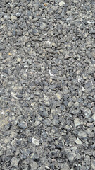 Close-up of crushed asphalt and gravel used as a base layer for road construction. This material improves stability, drainage, and durability, ensuring a solid foundation for paving and resurfacing.