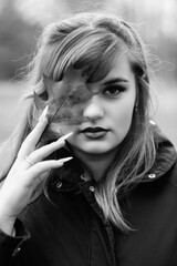 Obraz premium Portrait of a young beautiful long-haired girl in nature.