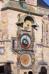 Facade of medieval castle in Prague city center with big clock