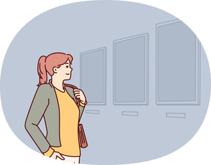 Woman visiting art gallery looks at paintings hanging on wall, painted by classical or contemporary artists. Young girl is in art exhibition hall contemplating work of famous painters.