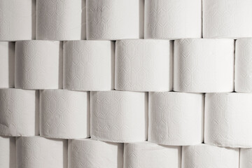 Many tissue paper rolls arranged in a brick wall