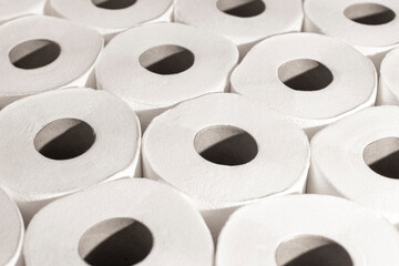 Tightly stacked multiple rolls of white toilet paper