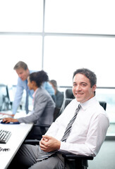 Portrait, businessman and smile in office, enterprise or regulatory affairs specialist coworking....