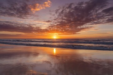 Fototapeta premium Sunset Over Ocean with Reflection on Wet Sand