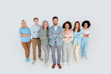 Fototapeta premium Group of diverse professionals standing together confidently against a grey background, showcasing teamwork, partnership, and leadership