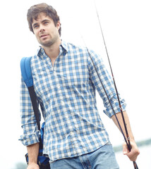 Man, fisher and walking with rod in nature with backpack for sport, hobby or catch by ocean. Male...