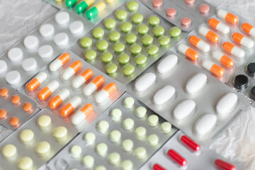 Big pharma metal tablet blister. Multicolor pills medicine. Silver shiny blister with drugs....