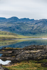 Fototapeta premium Scenic view of Lake Hraunsfjardavatn reflecting mountains in Berserkjahraun, Snæfellsnes Peninsula, West Iceland