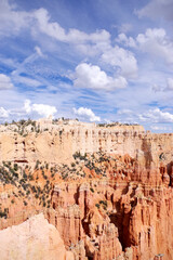 Towering White and Orange Cliffs Beneath Swirling Clouds