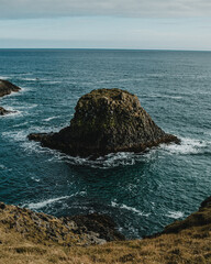 Lone basalt sea stack off the coast of Arnarstapi, Snæfellsnes Peninsula, West Iceland...