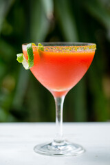 Bloody Mary cocktail in a glass with a lime garnish and seasoned rim