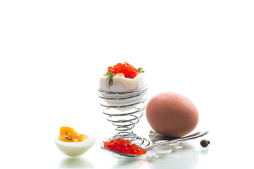 Breakfast with red caviar and boiled egg, isolated on white background
