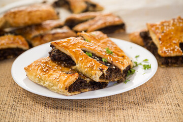 Golden puff pastries with mushroom filling and sesame seeds