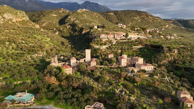 Aerial view of Mourtzinos Tower and Church of St. Spyridon during sunset in the town of Kardamyli on the Mani Peninsula, Greece.
