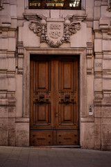 An ornate wooden door with intricate stone carvings in a historic building