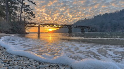 A rocky beach with smooth pebbles, sea stacks, and gentle waves rolling onto the shore under a cloudy sky