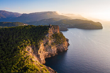 Aerial view coastline Port de Soller, Mallorca, featuring historic Torre Picada watchtower perched...