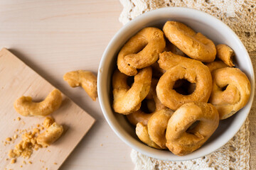 Artisanal homemade typical apulian taralli, used as a baked snack in south italian culture.