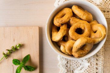 Artisanal homemade typical apulian taralli, used as a baked snack in south italian culture.