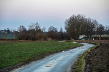 Bending road through the Flemish countryside at dusk in Tienen, Belgium