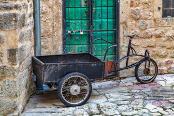 Rusty tricycle on the street in old town