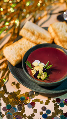 Fruit berry soup with biscuits on New Year's decor table
