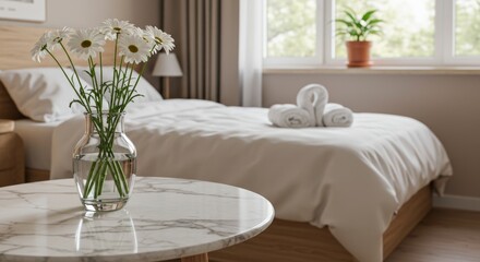 Modern minimalist bedroom with a white marble table, white daisies, neatly made bed, and natural light

