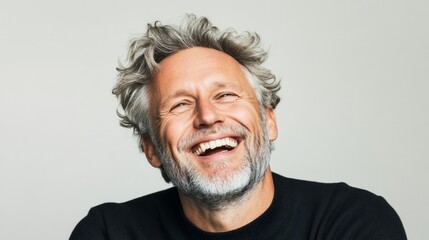 Obraz premium A happy middle-aged man with a beard smiling with a happy expression.