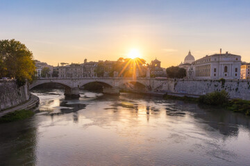 Bridge crossing the Tiber River in Rome Italy at sunset