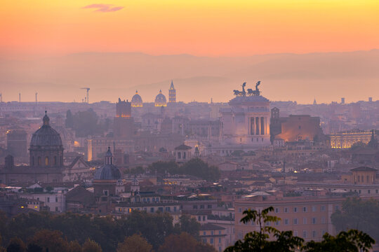 Vibrant sunrise over the city of Rome seen from the Terrazza del Gianicolo and Piazzale Giuseppe Garibaldi. Cityscape of the Capital of Italy