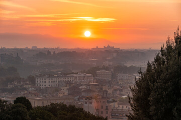Vibrant sunrise over the city of Rome seen from the Terrazza del Gianicolo and Piazzale Giuseppe Garibaldi. Cityscape of the Capital of Italy