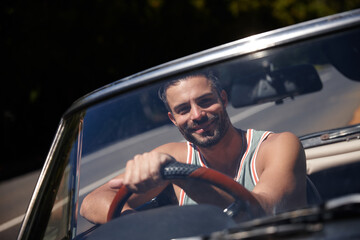 Happy, car and portrait of man on road trip in convertible for vacation, getaway or holiday with...