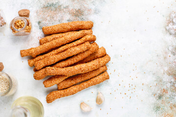 Italian grissini or salted bread sticks with sesame seeds.