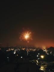 Festive fireworks for the new year over the city. Panorama of the night and evening city with houses.