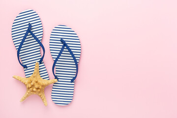 Striped blue flip-flops on color background, top view