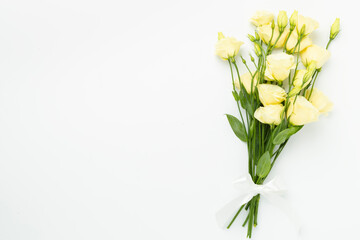 Beautiful bouquet with eustoma flowers on color background, top view