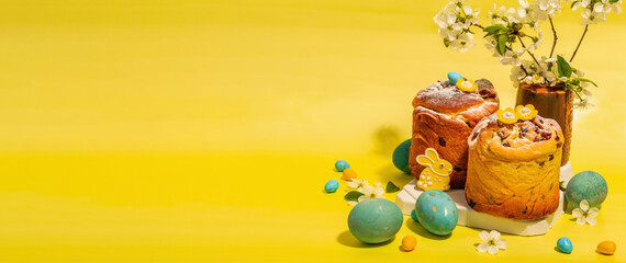 Easter cake Cruffin or sweet bread kulich. Traditional festive baking and blooming cherry branches