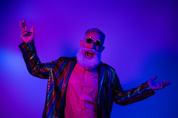 Fototapeta premium Photo of funky cool mature guy dressed glamour costume star eyewear dancing disco emtpy space isolated neon purple color background