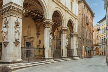 Fototapeta premium Old street in the historical center of Siena, the UNESCO World Heritage Centre unchanged for 13-14 centuries, with its medieval streets looked like in the early Middle Ages. Italy, 2019 