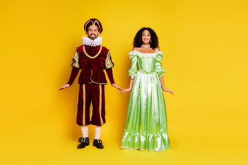 Romantic Couple in Elegant Period Costumes on a Bright Yellow Background for a Themed Carnival