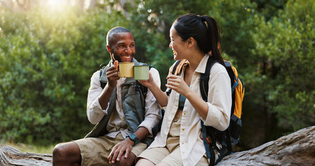 Cheers, coffee and hiking with interracial couple in nature for lunch break, trekking adventure and park conservation. Drinking, conversation and environment with man and woman in forest for peace