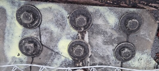 Metal bolts on foot bridge in winter with cold rime closeup