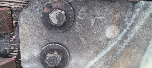 Metal bolts on foot bridge in winter with cold rime closeup
